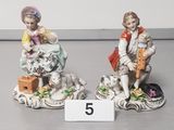 two figurines that are sitting next to each other