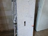 a white door with a hole in the middle of it