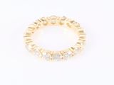 a gold ring with white stones on a white background