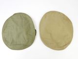 pair of green and khaki round cushions on a white surface
