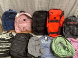 a lot of backpacks that are lined up on a table