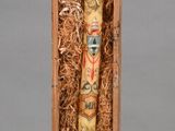 a wooden box with a tube of toothpaste inside of it
