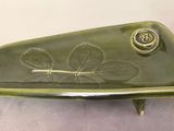 a green plate with a leaf on it on a table