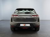 the rear end of a silver suv parked in a room