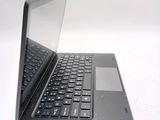 a laptop computer that is open on a white surface