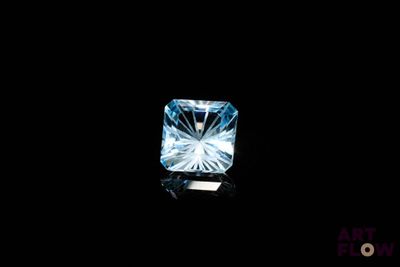 a close up of a blue diamond on a black background