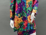 a mannequin wearing a multicolored dress with flowers on it
