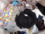 a pile of clothes that is on a couch