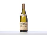a bottle of white wine sitting on top of a table