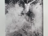 black and white photograph of a woman in a bathing suit in the ocean