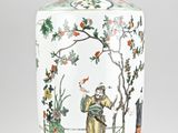 a vase with a painting on it sitting on a table