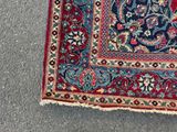 rug on the ground with a cat laying on top of it