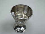 a silver cup that is sitting on a table