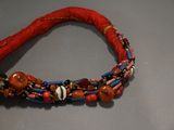 a close up of a bracelet with beads on a table