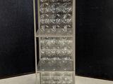 an image of a tall metal shelf with glass bottles on it