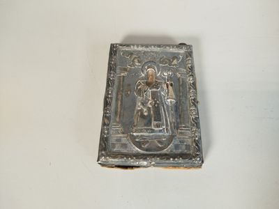 an old silver plate with a picture of a man and a woman