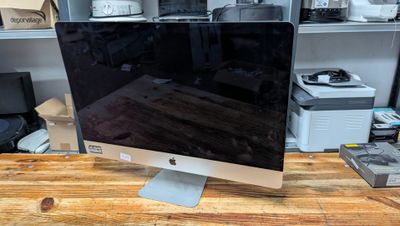 a computer monitor sitting on top of a wooden desk