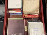 many books in a red box on a desk