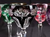 many wine glasses lined up in a row on a table