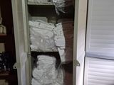 a tall cabinet that has a lot of items inside of it