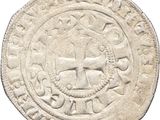 a white coin with an image of a man on it