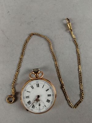 an antique pocket watch with a chain attached to it