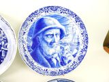 three plates with blue and white designs on them on a table