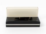the pen is sitting on top of a black book