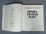 an open book with a picture of a bunch of papers on it