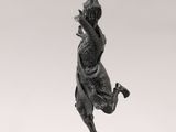 a bronze statue of a woman dancing on a pedestal