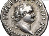 a silver coin with a woman ' s head and a crown on it