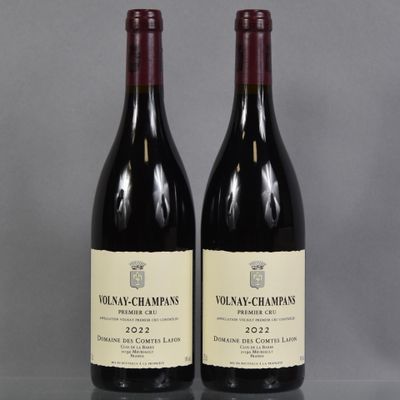 two bottles of wine sitting on top of a table next to each other