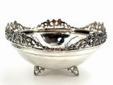 a silver bowl that is sitting on a stand