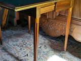 a table with a green cloth on it in a room