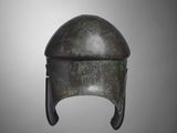 a bronze helmet on a gray background