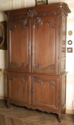 a large wooden cabinet in the corner of a room