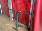 a red wall behind a metal fence with a red tarp