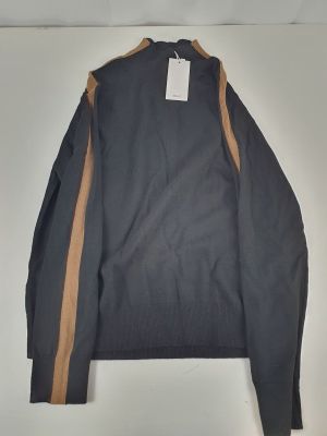 a blue sweater with a brown stripe on the side