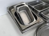 many trays of food sitting on the counter