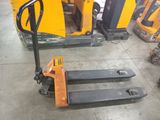 a picture of a forklift in a warehouse with other equipment