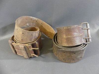 two belts that are sitting next to each other on a table