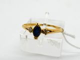 an image of a gold ring with a blue stone in it