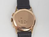 a close up of a watch on a white surface