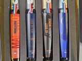 four lighters in a metal box on a table