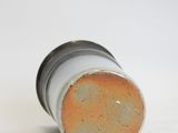 a close up of a white and orange vase