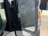 a side view mirror of a truck with a reflection of a person in it