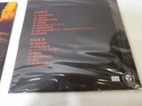 the back cover of a cd with a picture of a fire in the background