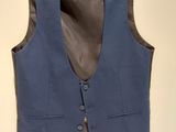 an image of a blue vest hanging on a wall