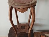 a small wooden table with a glass top on a wooden chair