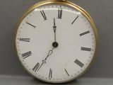 a gold clock with roman numerals on the face